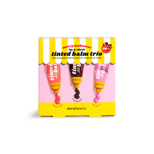 Load image into Gallery viewer, Avry Beauty tinted balm trio packaging with three lip balms on a yellow and pink striped background.